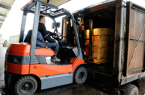 Unloading boxes from container with forklift