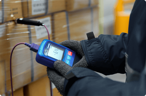 Worker checking shipment temperature